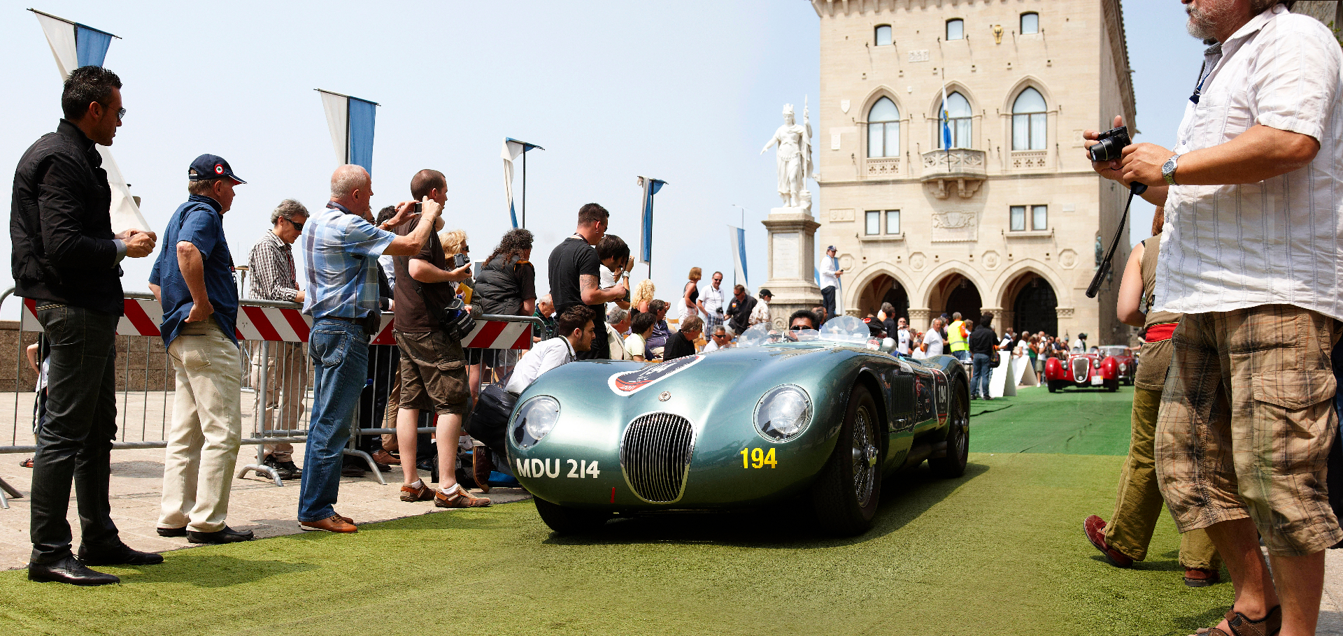 Patrick Hong driving a green Jaguar C-Type at the Mille Miglia in San Marino