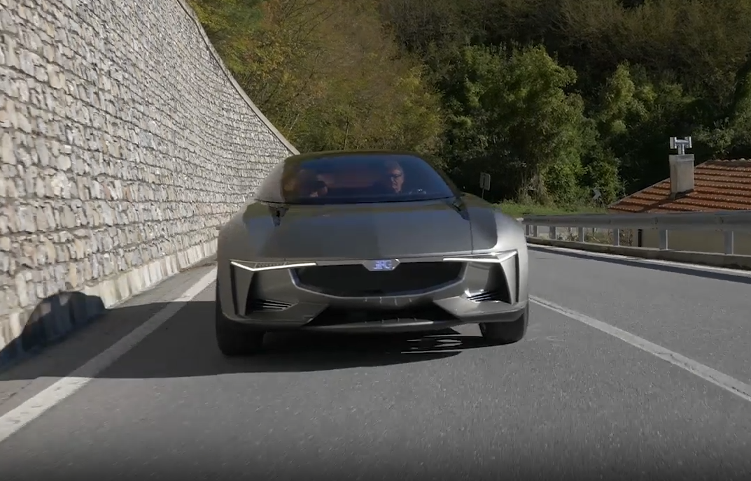 Front view of the Giugiaro Sibylla GG80 driving on a road